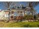 Charming two-story house with a stone retaining wall and landscaped lawn at 204 Dalmeny Dr, Cary, NC 27513