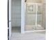 Bathroom featuring a tiled shower with glass door and shelving at 24 Surles Landing Way, Benson, NC 27504