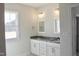 Bright bathroom with double sink granite vanity, modern fixtures, and a window at 24 Surles Landing Way, Benson, NC 27504