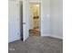 Neutral bedroom with gray carpet and a glimpse of the ensuite bathroom with a granite countertop at 24 Surles Landing Way, Benson, NC 27504