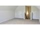 Spacious bonus room featuring neutral carpeting and access to additional storage behind small doors at 24 Surles Landing Way, Benson, NC 27504