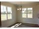 Well lit dining room with three large windows and luxury chandelier at 24 Surles Landing Way, Benson, NC 27504