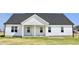 Charming front elevation of a white home with dark roof and a covered porch at 24 Surles Landing Way, Benson, NC 27504