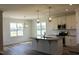 Open kitchen with granite countertops, stainless steel appliances, and decorative lighting at 24 Surles Landing Way, Benson, NC 27504