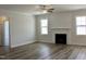 Open concept living room with fireplace, lots of natural light, and hardwood floors at 24 Surles Landing Way, Benson, NC 27504