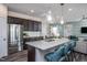 Open concept kitchen features stainless steel appliances and granite island at 2907 Huxley Way, Apex, NC 27502
