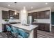 Island kitchen with teal barstools and stainless steel appliances at 2907 Huxley Way, Apex, NC 27502