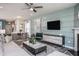 Living area features a sectional sofa and a large flat screen TV at 2907 Huxley Way, Apex, NC 27502