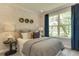 Spacious bedroom with large window, plush bedding, and stylish wall decor at 2940 Hanging Valley Way, Wake Forest, NC 27587