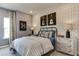 Bedroom with a striped bedspread, guitar wall art, and metal nightstands at 2940 Hanging Valley Way, Wake Forest, NC 27587