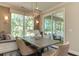 Bright dining area with built-in bench seating and sliding glass doors leading to a screened porch at 2940 Hanging Valley Way, Wake Forest, NC 27587