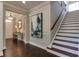 Elegant entryway with hardwood floors and statement art at 2940 Hanging Valley Way, Wake Forest, NC 27587