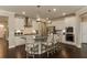 Modern kitchen with white cabinets, a large island, and stainless steel appliances at 2940 Hanging Valley Way, Wake Forest, NC 27587