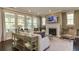 Spacious living room with a fireplace and large windows at 2940 Hanging Valley Way, Wake Forest, NC 27587