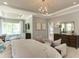 Main bedroom with large bed, sitting area, and access to the bathroom at 2940 Hanging Valley Way, Wake Forest, NC 27587