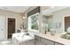 Elegant bathroom with soaking tub, dual vanities, and a large window at 2948 Hanging Valley Way, Wake Forest, NC 27587