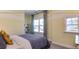 Bright bedroom with large window, gray bedding, and built-in shelving at 2948 Hanging Valley Way, Wake Forest, NC 27587
