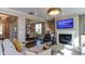 Open living room with fireplace, large windows, and comfortable seating at 2948 Hanging Valley Way, Wake Forest, NC 27587