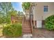 Back exterior of home features stairs leading to a deck with mature trees in the background at 306 Neuse Ridge Dr, Clayton, NC 27527