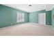 Well-lit carpeted basement featuring a neutral color scheme, with a window and a closet at 306 Neuse Ridge Dr, Clayton, NC 27527