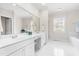 Bright bathroom featuring double sink vanity with lots of counter space and a large mirror at 306 Neuse Ridge Dr, Clayton, NC 27527