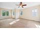 Spacious bedroom with neutral walls, a ceiling fan, carpeted floors and bright, sun-filled windows at 306 Neuse Ridge Dr, Clayton, NC 27527