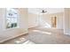 Bedroom features neutral walls, carpet, a ceiling fan and bright, sun-filled windows at 306 Neuse Ridge Dr, Clayton, NC 27527
