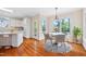 Eat in kitchen with white cabinets, granite countertops, and a breakfast nook with hardwood flooring at 306 Neuse Ridge Dr, Clayton, NC 27527