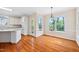 Eat-in kitchen boasts wood floors, lots of natural light from large windows, and a neutral color palette at 306 Neuse Ridge Dr, Clayton, NC 27527
