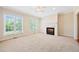 Bright living room with a fireplace, large windows providing natural light, and a neutral color scheme at 306 Neuse Ridge Dr, Clayton, NC 27527