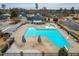 Stunning overhead view of a large community pool area with colorful umbrellas and slides at 306 Neuse Ridge Dr, Clayton, NC 27527