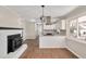 Modern kitchen with white cabinets, granite counters, and a wood-burning stove at 4015 Lake Wendell Rd, Wendell, NC 27591