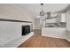 Modern kitchen with white cabinets, granite counters, and a wood-burning stove at 4015 Lake Wendell Rd, Wendell, NC 27591