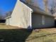 Side view of home displaying beige siding and a dark roof, set within a yard at 415 Sowell St, Durham, NC 27701
