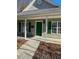 Green front door entry to a charming house at 415 Sowell St, Durham, NC 27701