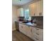 Well-lit kitchen featuring stainless steel appliances and white cabinets at 415 Sowell St, Durham, NC 27701