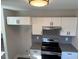 Modern kitchen featuring white cabinets, stainless steel appliances, and patterned backsplash at 415 Sowell St, Durham, NC 27701