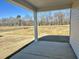 Covered patio overlooking a grassy backyard and wooded area at 456 Glover Park Memorial Drive, Nashville, NC 27856