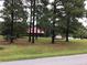 House nestled amongst tall trees on a spacious lot at 515 Docs Rd, Lillington, NC 27546