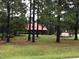 House nestled amongst tall trees on a spacious lot at 515 Docs Rd, Lillington, NC 27546