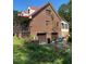 Brick home with attached two-car garage, red roof, and spacious porch at 515 Docs Rd, Lillington, NC 27546