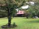 Brick home with red metal roof and large yard at 515 Docs Rd, Lillington, NC 27546