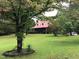 Brick home with red metal roof and large yard at 515 Docs Rd, Lillington, NC 27546
