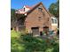 Brick home with attached two-car garage, red roof, and spacious porch at 515 Docs Rd, Lillington, NC 27546