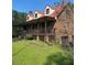 Brick home with long wrap-around porch and red metal roof at 515 Docs Rd, Lillington, NC 27546