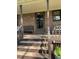 Front entrance with steps leading up to a porch with a bench at 515 Docs Rd, Lillington, NC 27546