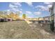 Spacious backyard featuring a large grassy area, fence, and mature trees at 575 Crystal Spring Dr, Sanford, NC 27332