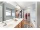 Bright bathroom featuring a soaking tub, double sink vanity, and a large mirror at 575 Crystal Spring Dr, Sanford, NC 27332