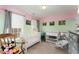 Charming Bedroom with a white crib, changing table, and coordinated decor at 575 Crystal Spring Dr, Sanford, NC 27332