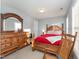 Cozy bedroom with wood furniture, a ceiling fan, and natural light from the window at 575 Crystal Spring Dr, Sanford, NC 27332
